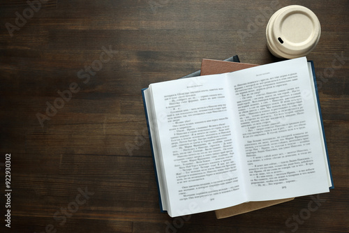 Books with a cup of coffee on a wooden background