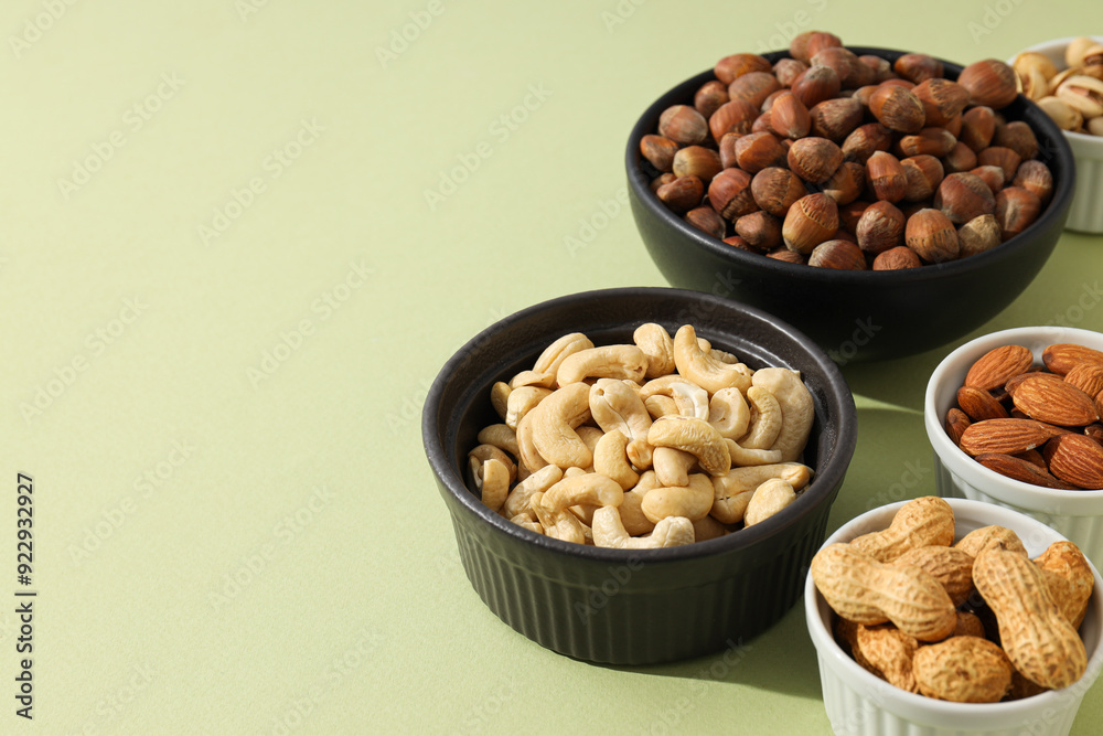 Various nuts in white and black bowls Various nuts in white and black bowls