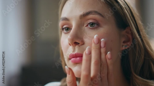 Beauty lady moisturizing skin at bathroom closeup. Woman applying face cream