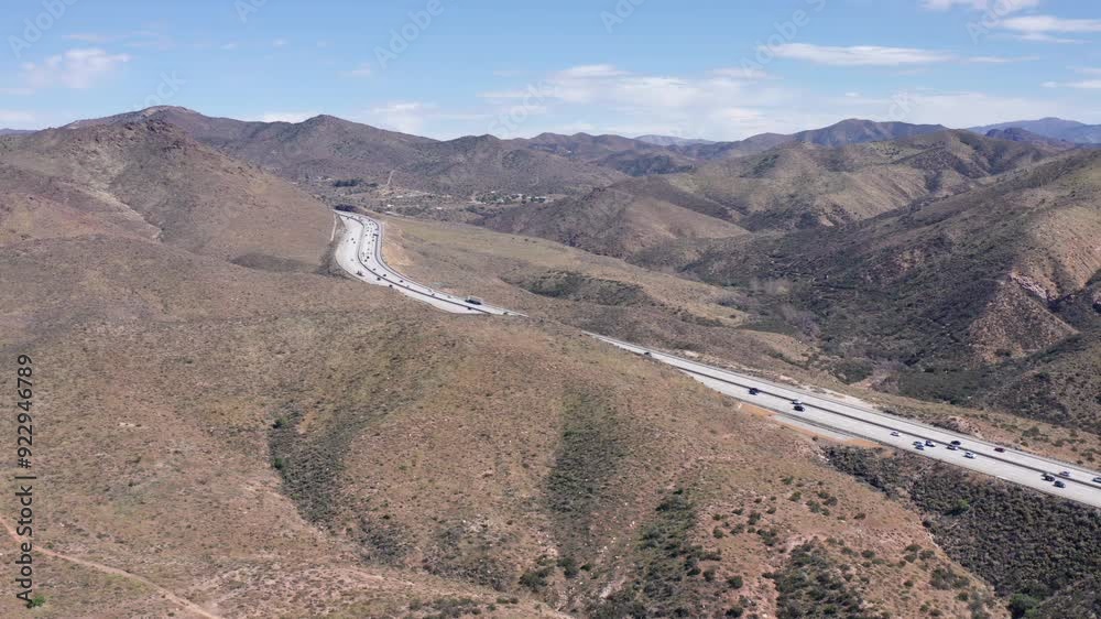 Aerial view of California desert landscape with winding highway traffic Aerial view of California desert landscape with winding highway traffic