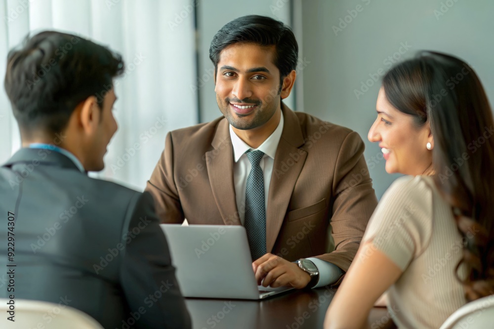An Indian financial consultant discussing portfolio strategies with clients, usually in a professional office or meeting room.
An Indian financial consultant discussing portfolio strategies with clients, usually in a professional office or meeting room.