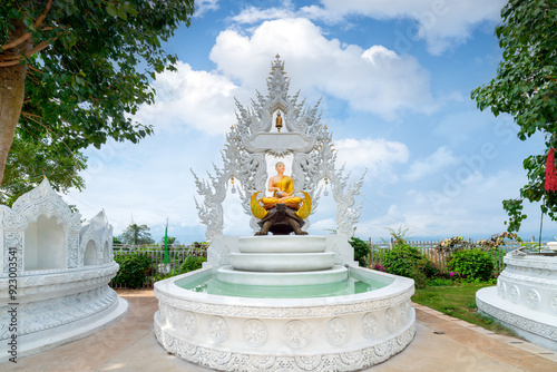 The white pagoda of Prajna Temple in Xishuangbanna, Yunnan, China. photo