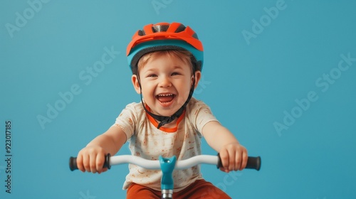 photo of happy little boy riding balance bike wearing helmet
