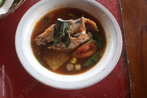 traditional Indonesian Palembang cuisine. Pindang Patin. snakehead fish pindang. Pindang Toman. pindang baung. smoked fish. Great dish for lunch and dinner served with rice photo