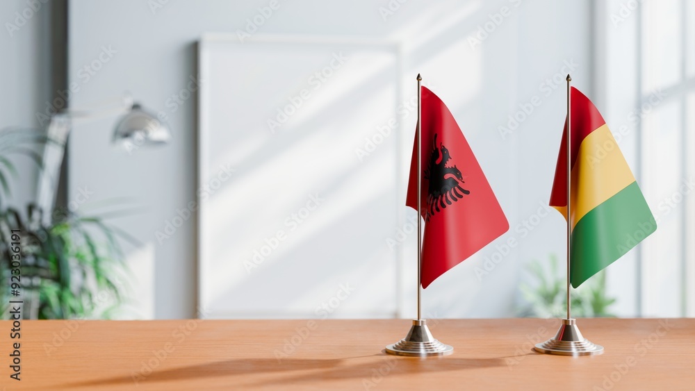 FLAGS OF ALBANIA AND GUINEA ON TABLE FLAGS OF ALBANIA AND GUINEA ON TABLE