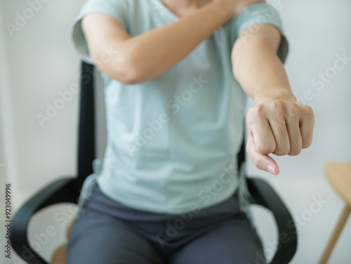 Asian businesswoman suffering from neck pain From sitting and working hard all day. By massaging her overworked neck. Health and office syndrome concept