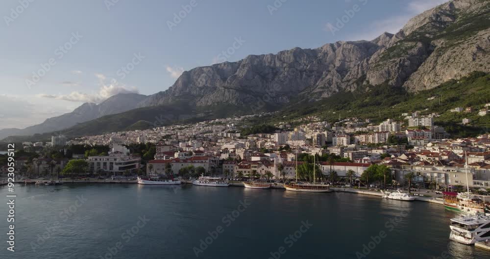 Boats Docked In A Marina At Makarska In Croatia At Sunrise. Travel Destination In Europe, Aerial Shot. Boats Docked In A Marina At Makarska In Croatia At Sunrise. Travel Destination In Europe, Aerial Shot.