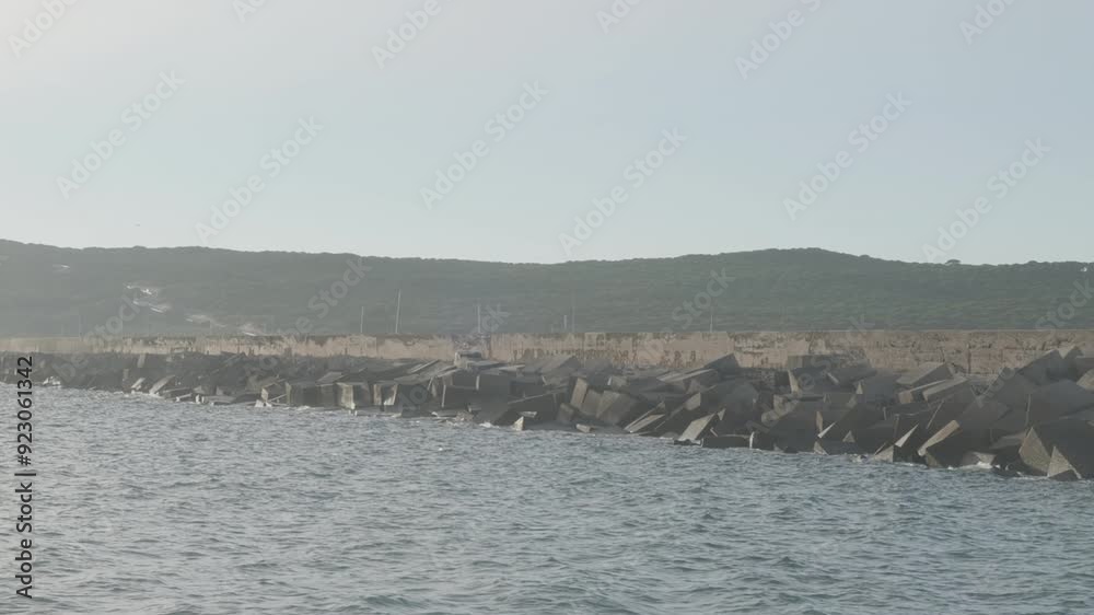 View of a breakwater from a boat