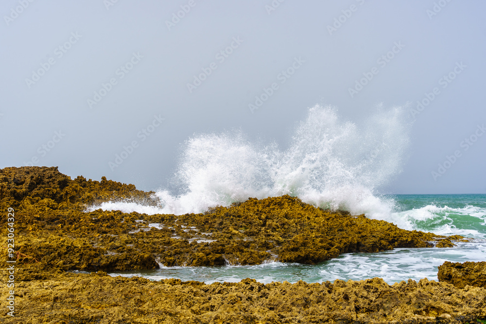 Waves crashing on the rocky beach, village resort Oualidia