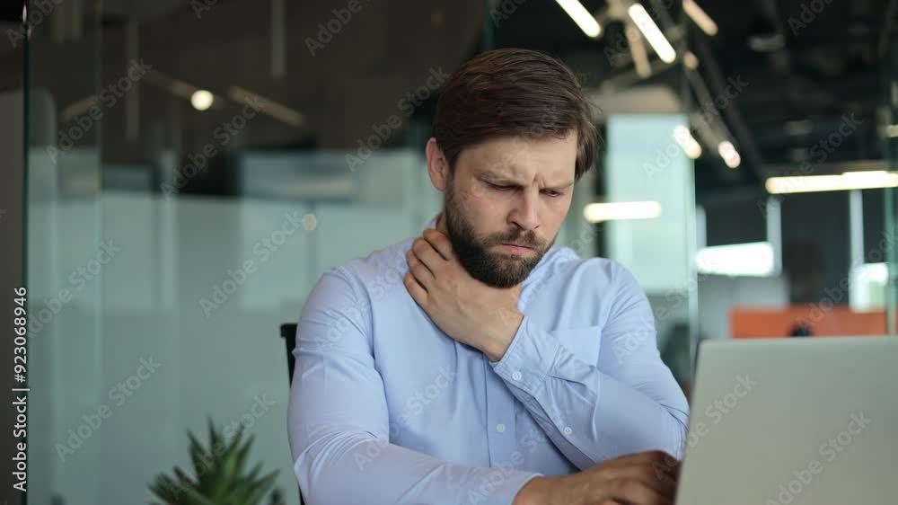 Sick business man employee blowing running nose sneezing and coughing while working on laptop at office. Unhealthy young office worker getting flu virus symptom at workplace. Cold and fever concept Sick business man employee blowing running nose sneezing and coughing while working on laptop at office. Unhealthy young office worker getting flu virus symptom at workplace. Cold and fever concept