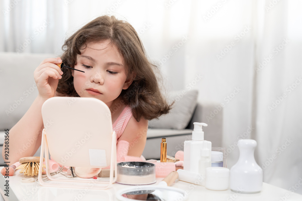 Happy children sit in front of a mirror makeup on face. Girl applying makeup. Advertisement, lifestyle , cosmetics, makeup accessories, beauty activity, beautician, talent, love beauty Happy children sit in front of a mirror makeup on face. Girl applying makeup. Advertisement, lifestyle , cosmetics, makeup accessories, beauty activity, beautician, talent, love beauty