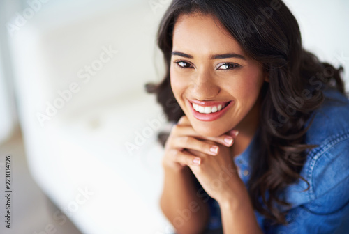 Calm, portrait and smile with woman in living room for satisfaction, relaxing and weekend. Face, rest and confident with happy female student on sofa at home for peace, carefree lounge break