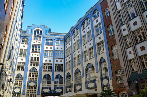 The façade of the house with large windows and a blue sky above it. Hackesche Hoefe is a notable courtyard complex located adjacent to Hackescher Markt in the center of Berlin.