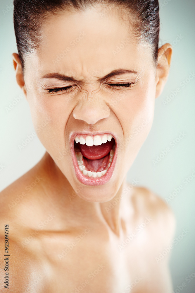 Woman, face and shout on studio background with anger, frustrated and rage. Female person, screaming and bad news with emotions for expression, mental health and cathartic exercise for psychology Woman, face and shout on studio background with anger, frustrated and rage. Female person, screaming and bad news with emotions for expression, mental health and cathartic exercise for psychology