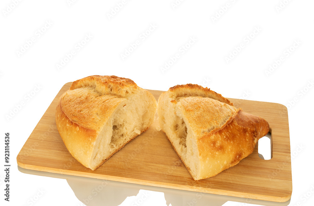 Two halves of white bread on a wooden kitchen board, macro, isolated on white background. Two halves of white bread on a wooden kitchen board, macro, isolated on white background.