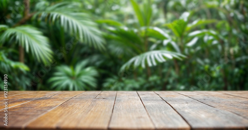 Empty wooden table with green space as background.