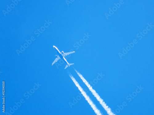 aircraft leaving white tracks in blue sky