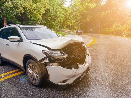 A white car had an accident on the road because the road was slippery because of rain