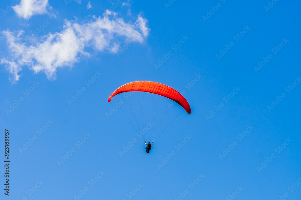 View of the sky. Person flying in a paraglider, leisure activity. Travel and landscapes. View of the sky. Person flying in a paraglider, leisure activity. Travel and landscapes.