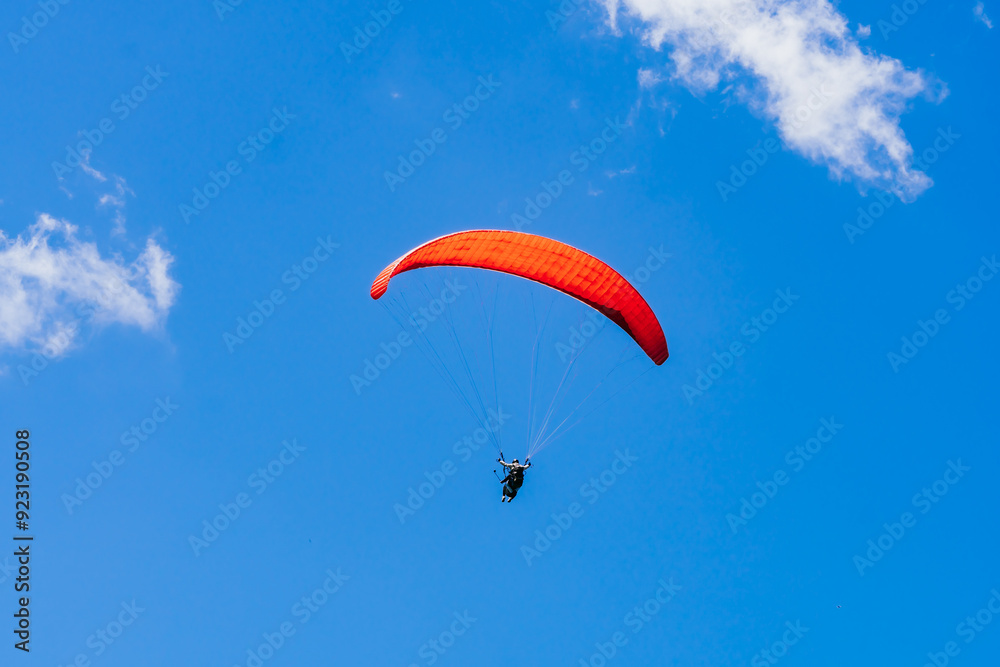 View of the sky. Person flying in a paraglider, leisure activity. Travel and landscapes. View of the sky. Person flying in a paraglider, leisure activity. Travel and landscapes.
