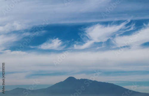 Selective focus silhouette of mountain with clear blue sky, beautiful view from indonesia toll road or highway road