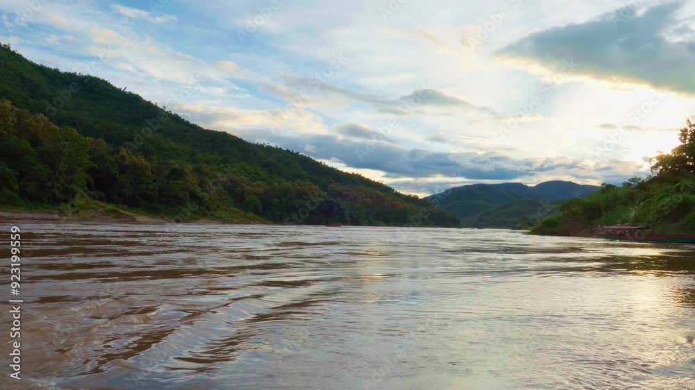 Tranquility during sunset time, riverside, hill and mountain background Tranquility during sunset time, riverside, hill and mountain background