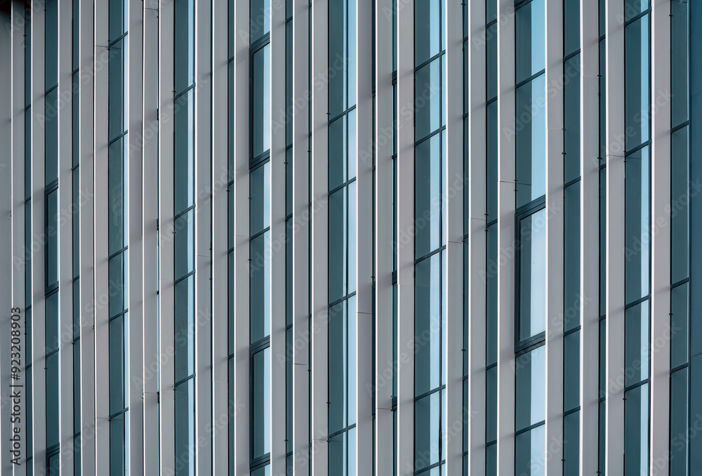 empty glass windows of a modern building with a reflection of the sky in the glass empty glass windows of a modern building with a reflection of the sky in the glass