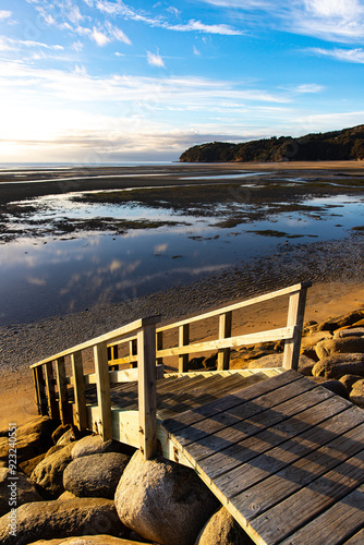 panorama of Sandy Bay seen from Marahau at sunrise - the start of famous Abel Tasman Coast Track in New Zealand South Island photo