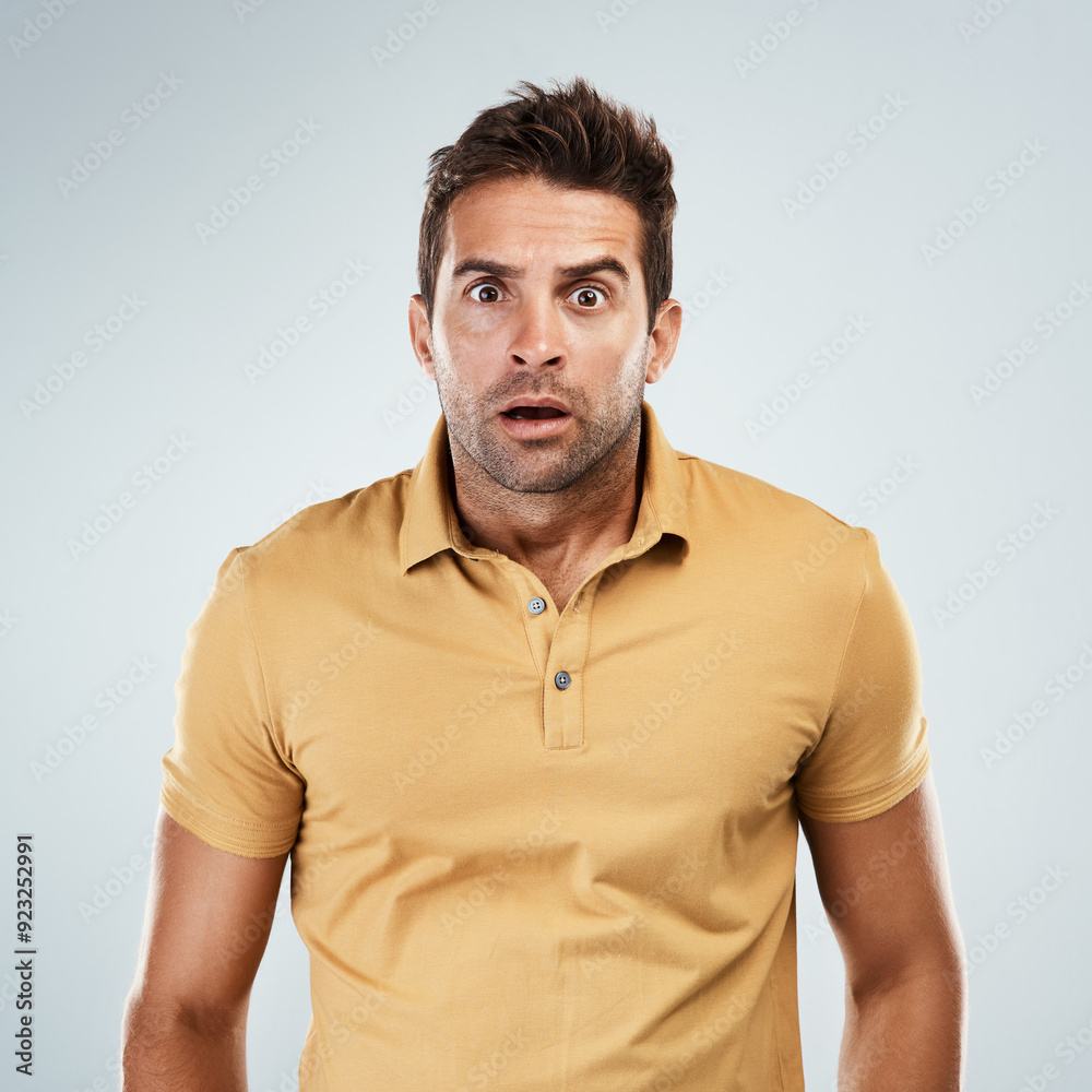 Fototapeta premium Portrait, man and surprise with worry in studio for fake news, announcement and horror of gossip information. Shocked, male person and facial expression for wow, drama secret and white background