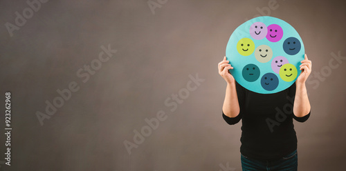 Holding a head with a sad and a happy face, mental health concept, positive and negative mind, depression, support and emotion, divided personality photo