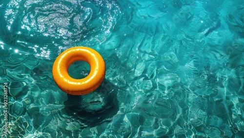 An inflatable ring drifts on the surface of a pool of clear water under the sunny sky