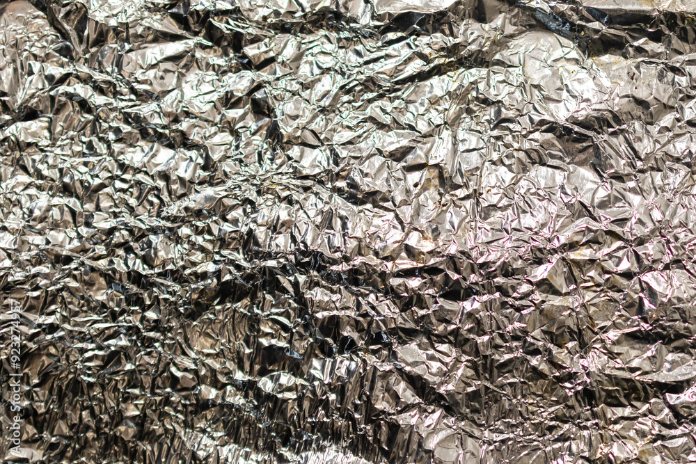 Crumpled white foil. Abstract glowing textured background. Holidays. New Year. Festive background Crumpled white foil. Abstract glowing textured background. Holidays. New Year. Festive background