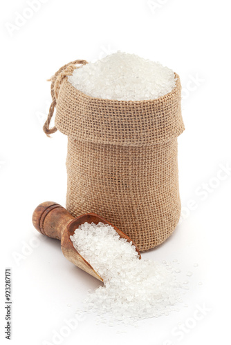 Close-up of refined white Sugar in a jute bag and on a scoop, isolated on a white background. photo