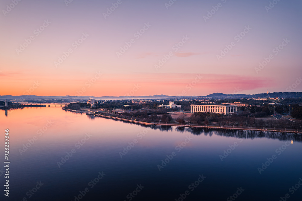 Scenic view of river by buildings against sky during sunset Scenic view of river by buildings against sky during sunset