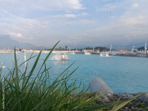 Fish pond tambak with blue water and clear sky. photo