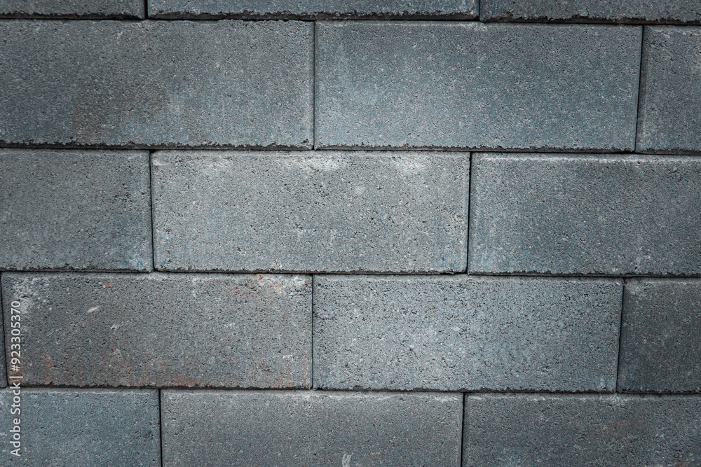 A gray brick wall with a rough texture A gray brick wall with a rough texture