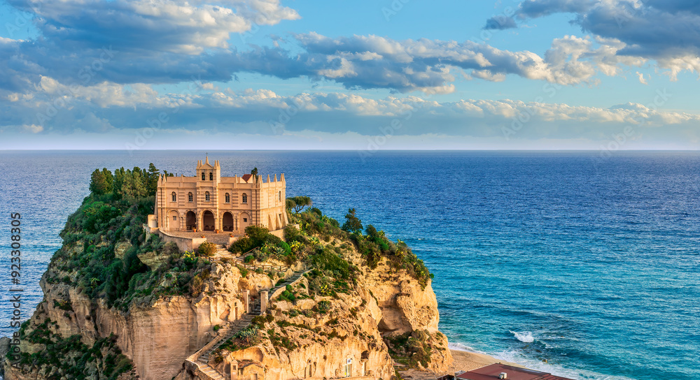sea landscape of beautiful white temple or castle on a high cliff isle on a rock in crystal clear turquoise sea with waves and beautiful sunset or sunrise on background of seascape sea landscape of beautiful white temple or castle on a high cliff isle on a rock in crystal clear turquoise sea with waves and beautiful sunset or sunrise on background of seascape