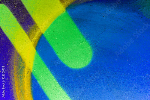 Beautiful colorful street art graffiti background. The wall is decorated with abstract drawings house paint. Modern style urban culture of street youth. Abstract picture on wall