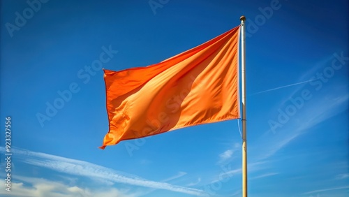 An orange flag blowing in the wind , flag, orange, wind, fluttering, symbolic, fabric, pole, bright, vibrant, outdoors