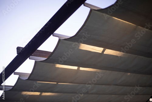 A porch made of wood and fabric. Lights on the veranda. Details of the building.