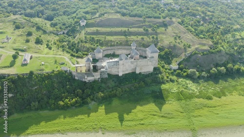 Khotyn Fortress (Ukrainian: Хотинська фортеця; Romanian: Cetatea Hotinului)  fortress of the 10th-18th centuries, huge walls towers on the banks  Dniester,  drone flies by at dawn aerial photography photo