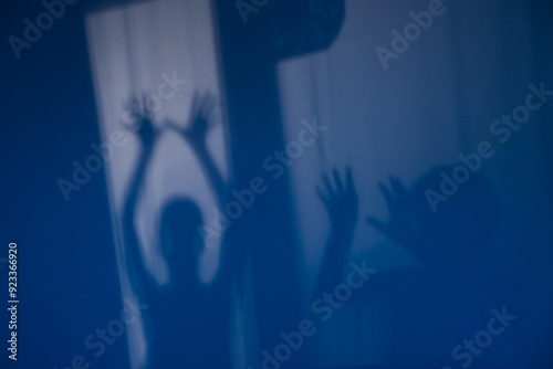 Creepy shadows of hands on the wall