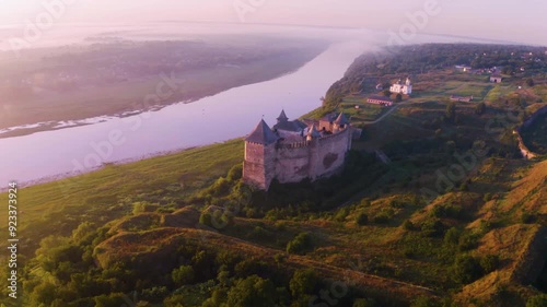 Khotyn Fortress (Ukrainian: Хотинська фортеця; Romanian: Cetatea Hotinului)  fortress of the 10th-18th centuries, huge walls towers on the banks  Dniester,  drone flies by at dawn aerial photography photo