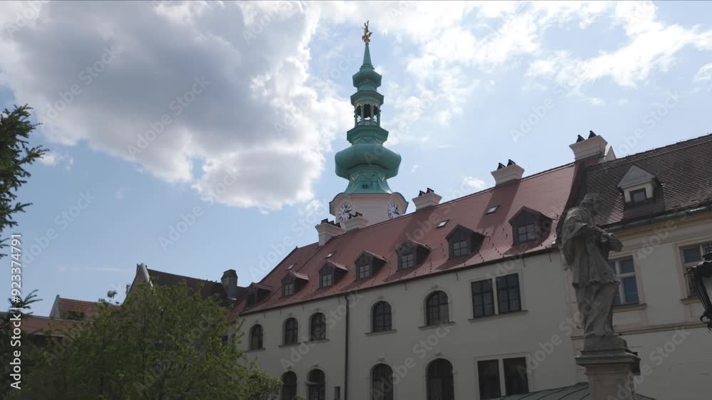 Michael's Tower in Bratislava on a sunny day with a view of historic buildings and green trees Michael's Tower in Bratislava on a sunny day with a view of historic buildings and green trees
