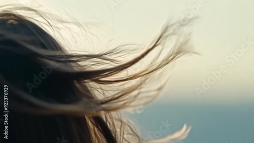 Close-up of woman's hair blowing in wind, symbolizing freedom, hope and new beginnings.