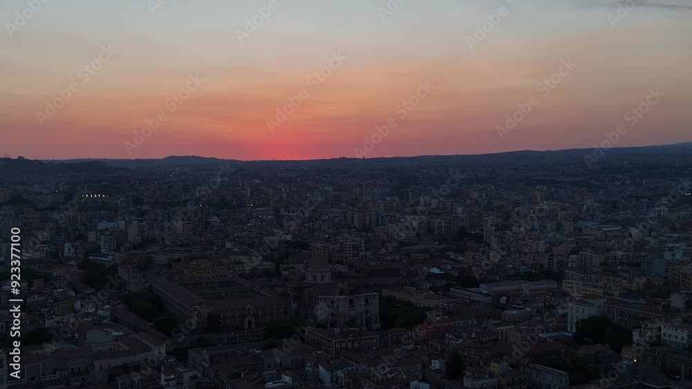 A cityscape at sunset with vibrant colors and distant mountains in the background, aerial view A cityscape at sunset with vibrant colors and distant mountains in the background, aerial view