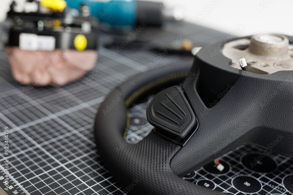 Repair of a leather car steering wheel in an auto repair shop on the table. Repair of a leather car steering wheel in an auto repair shop on the table.