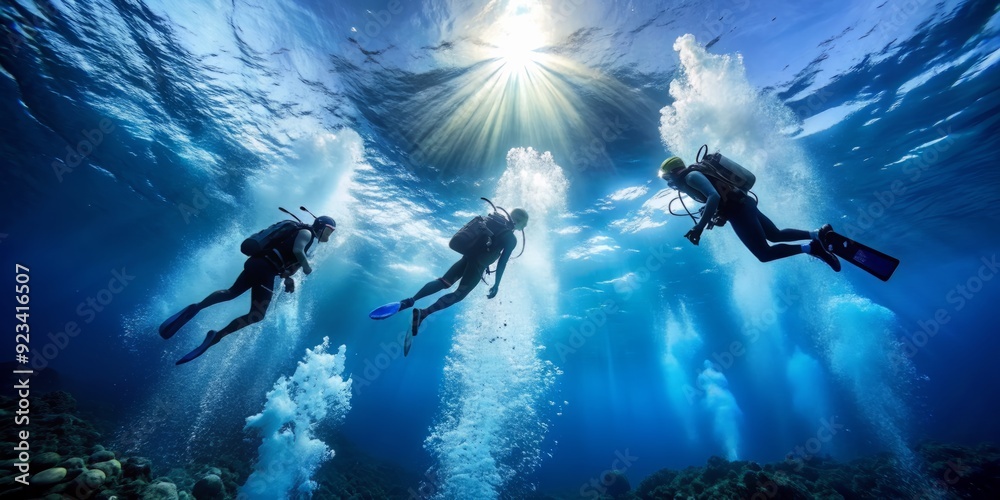 Three scuba divers' air bubbles rise as they swim upwards, oxygen cylinders visible, surrounded by calm blue water with ample copy space above the surface.