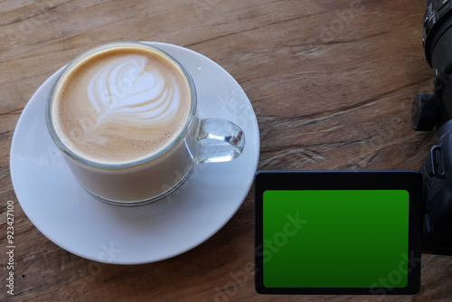 A cup of coffee on a camera with a cappuccino and foam