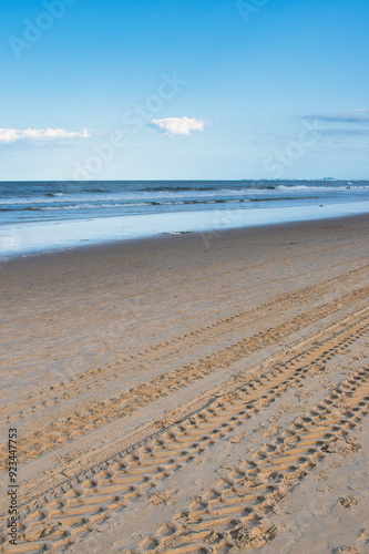 Surfers Paradise, Gold Coast, Australia - April 07, 2022 : People walking along the beach with high-rises in the background. photo